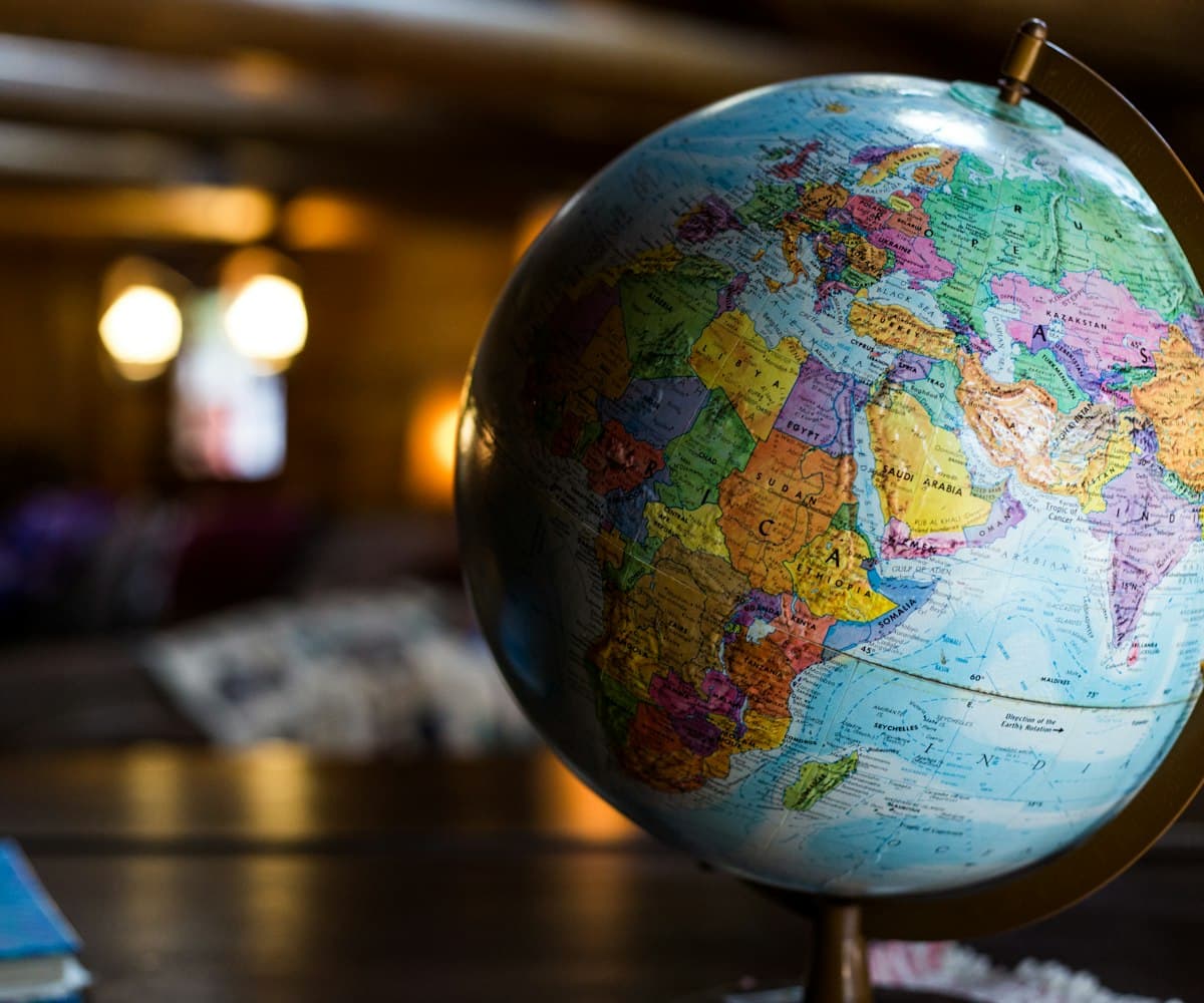 A desk globe beside a window