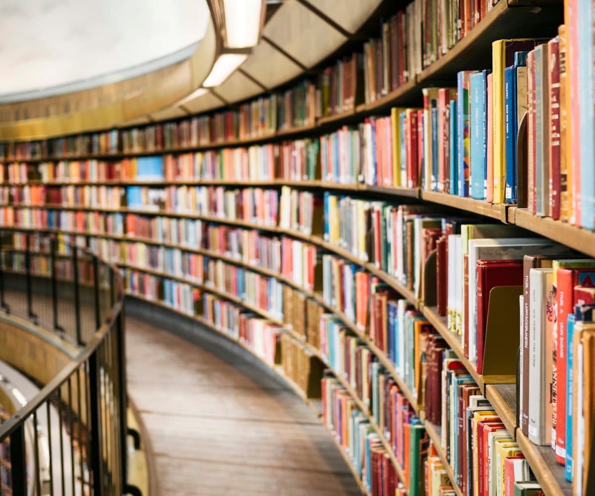 Curved library shelves filled with books
